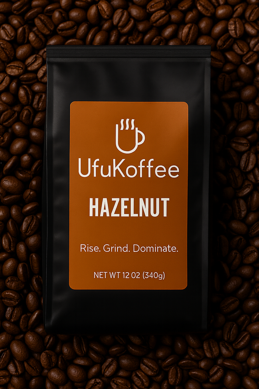 UfuKoffee hazelnut flavor specialty coffee beans in a black 12 oz bag on roasted coffee beans background